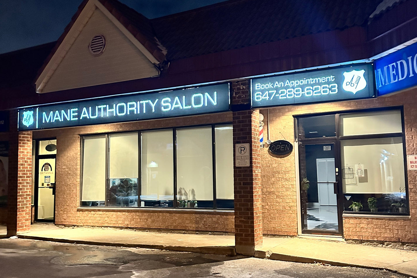 Salon entrance with illuminated sign and door